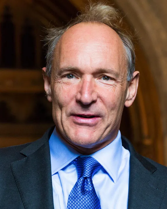 Portrait photo of Sir Tim Berners-Lee, a man with short grey hair, smiling.